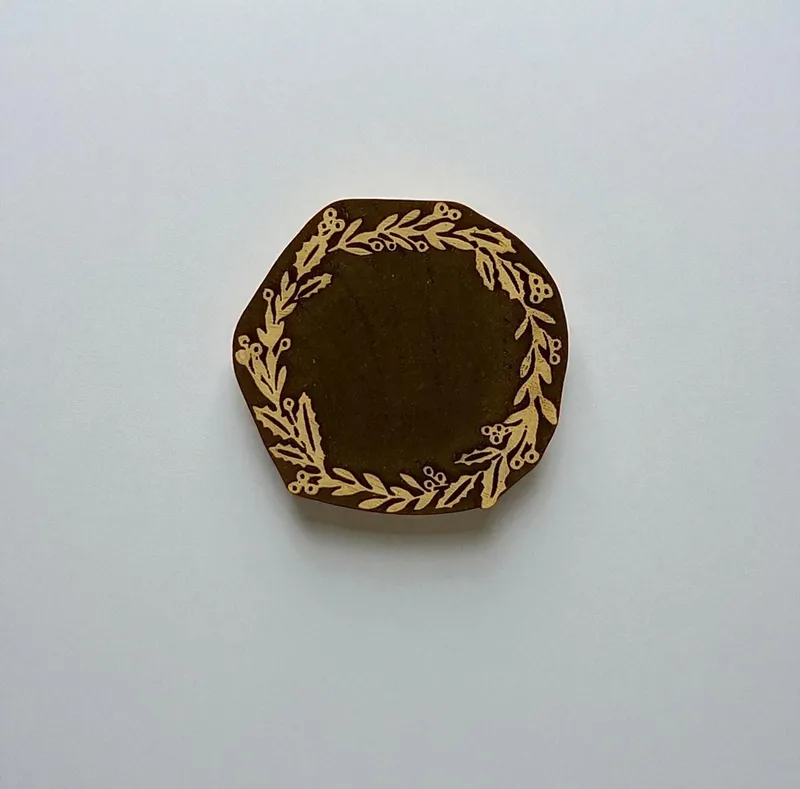 Wreath of Christmas and carved Indian wood printing block; textile stamp; pottery stamp,