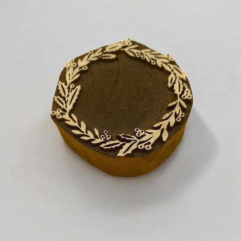 Wreath of Christmas and carved Indian wood printing block; textile stamp; pottery stamp,